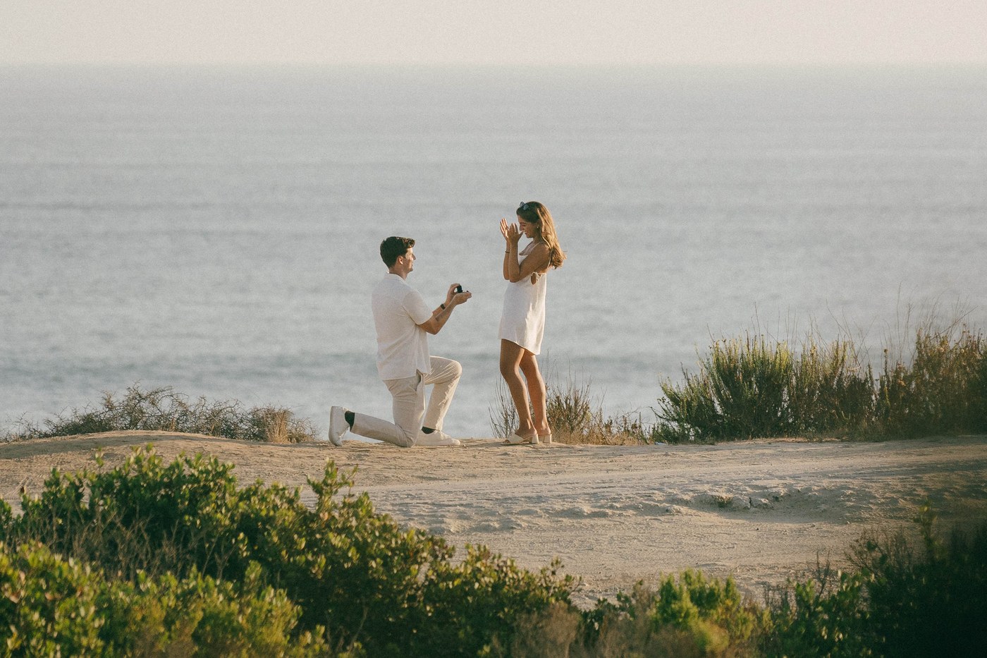 The moment he knelt, the whole bluff and the ocean around them
