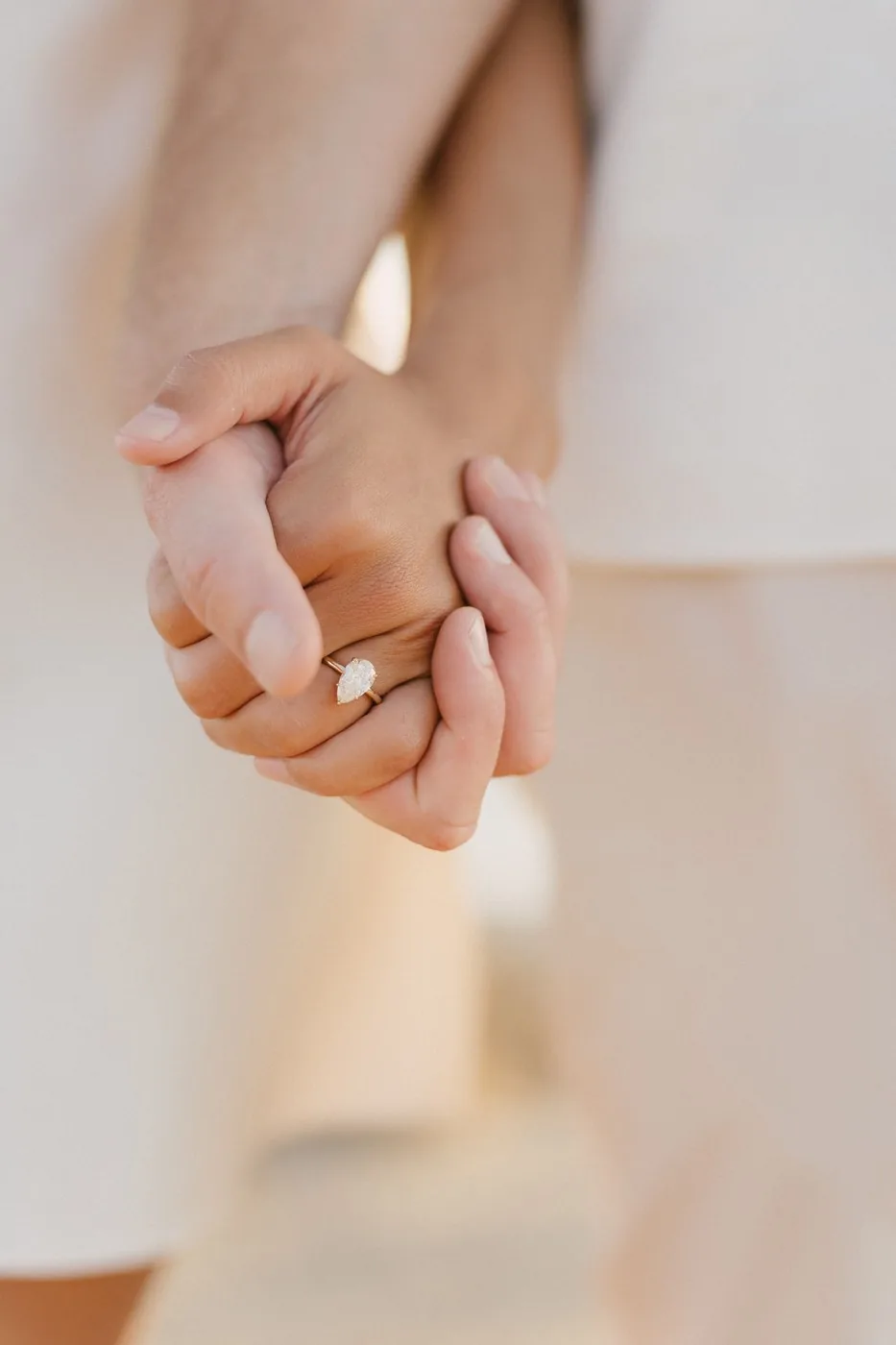 Their hands, and the ring between them