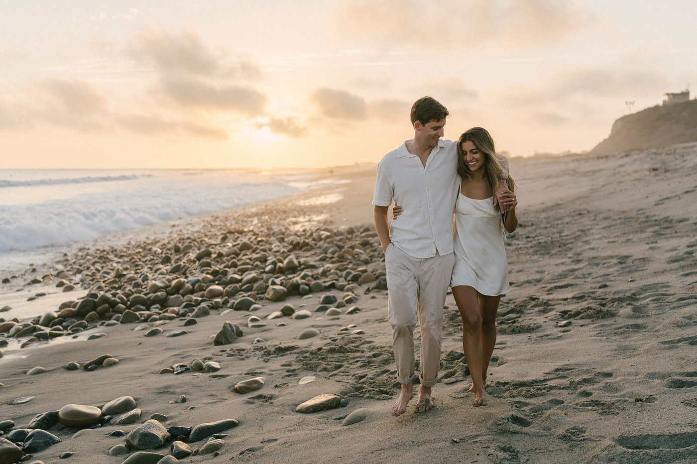 Walking the tideline, the sun behind them