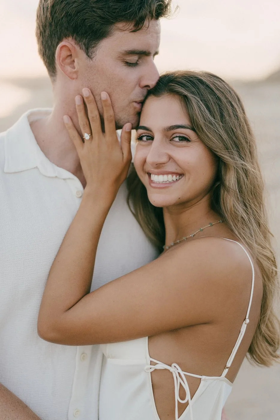 Her hand on his face, the ring against his cheek