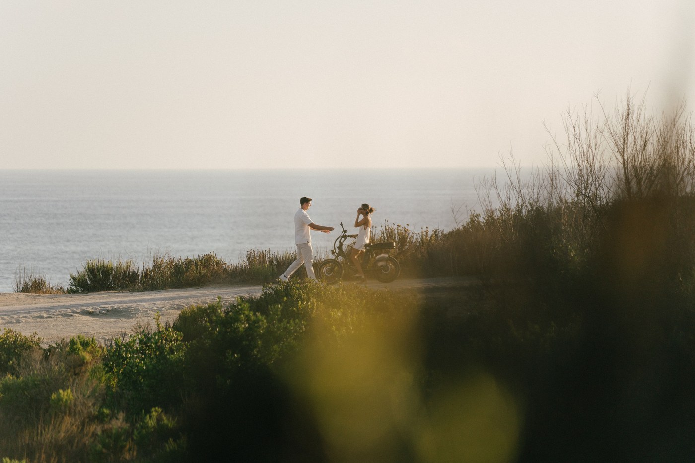 Cameron and Sabrina walking out to the point with the bike