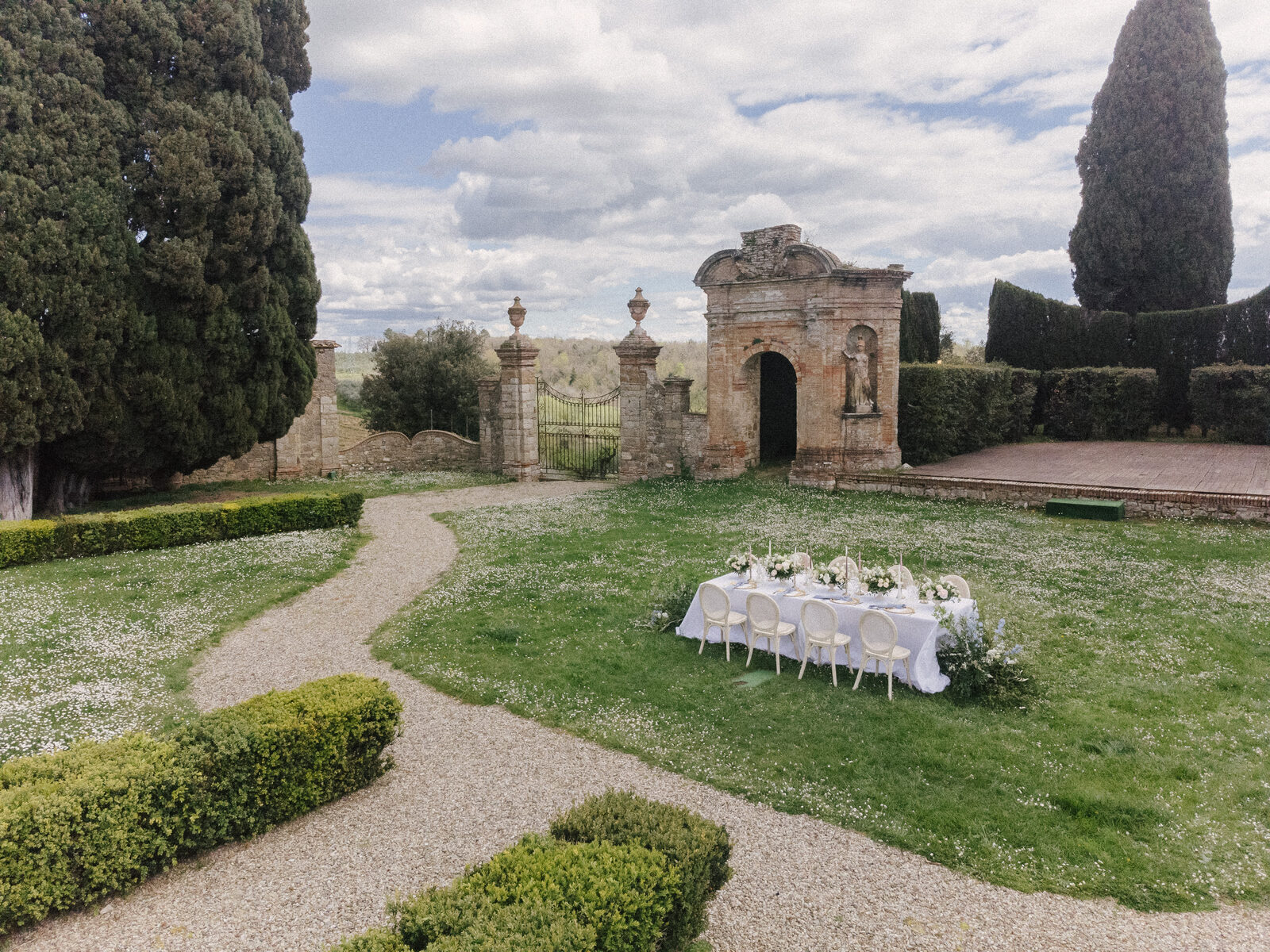 The garden table at Villa di Geggiano, with the gate behind