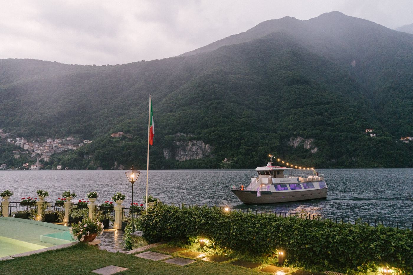 A boat arriving at the dock at dusk