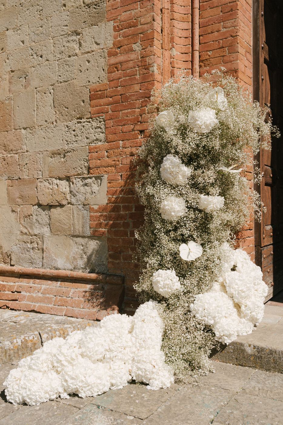 White flowers against the brick