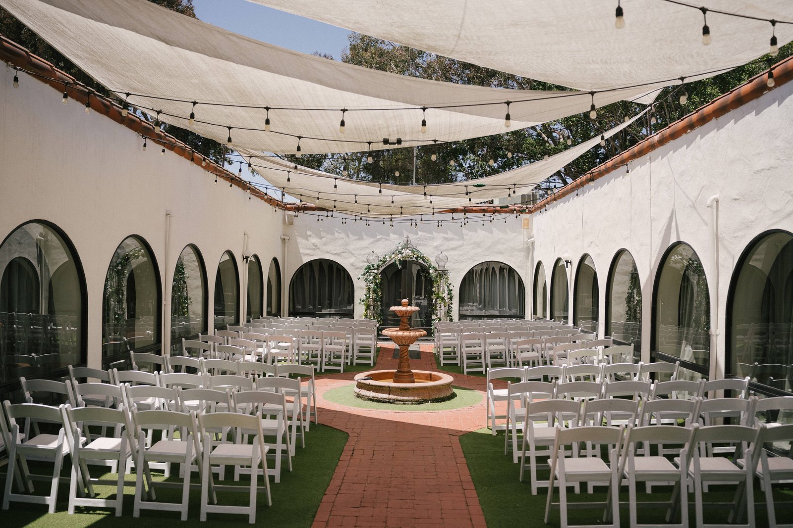 The arcaded courtyard set for the ceremony, with the fountain at its centre
