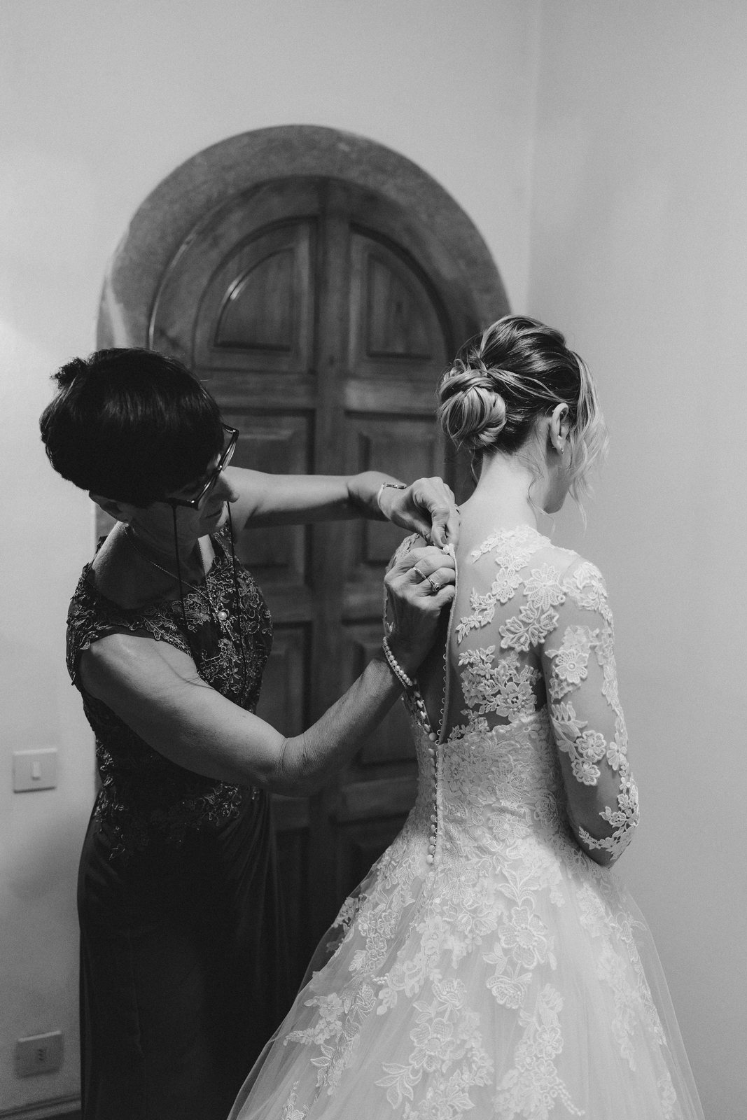 In the doorway, in black and white