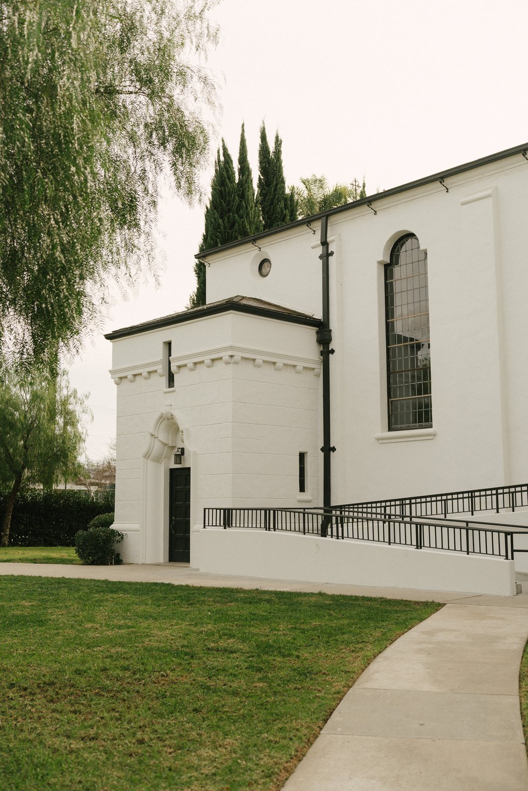 A mission chapel and a pepper tree