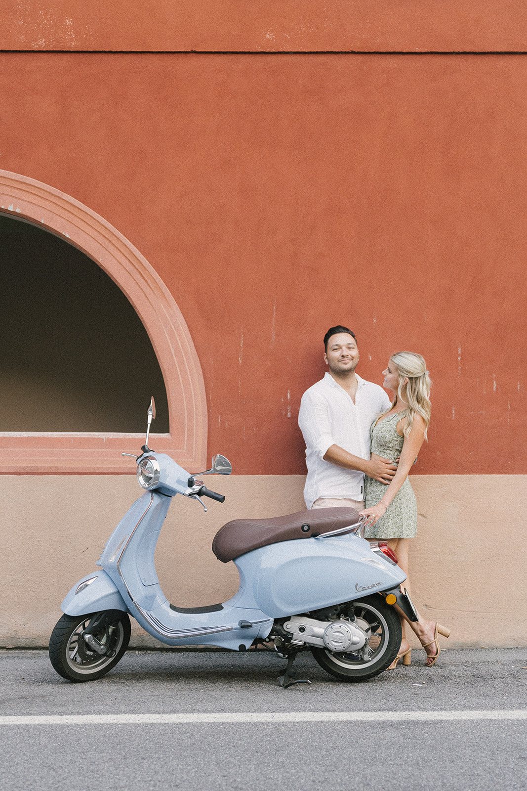 A Vespa, and a red wall