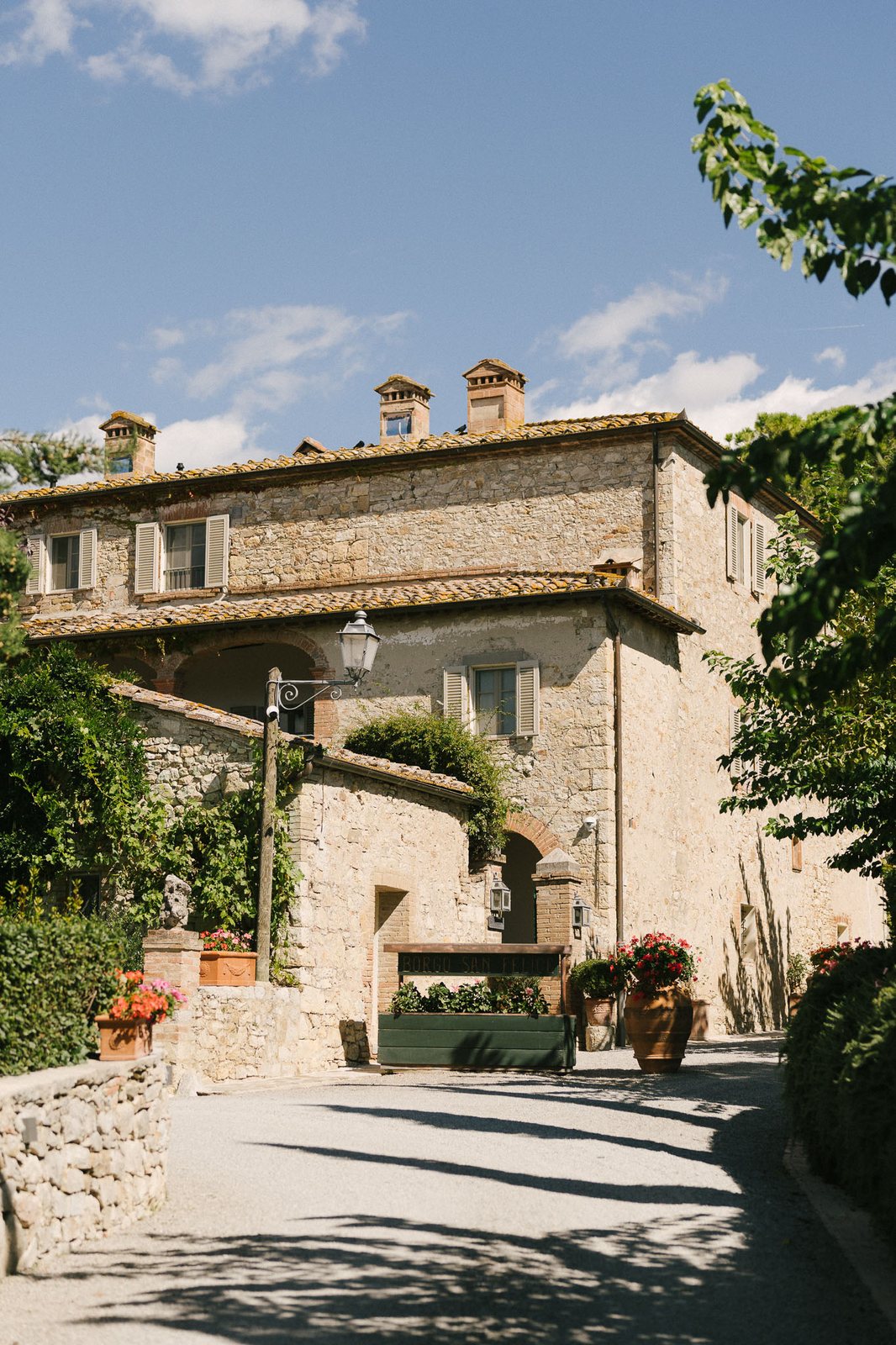 A stone villa under a hard midday sky — after the preset