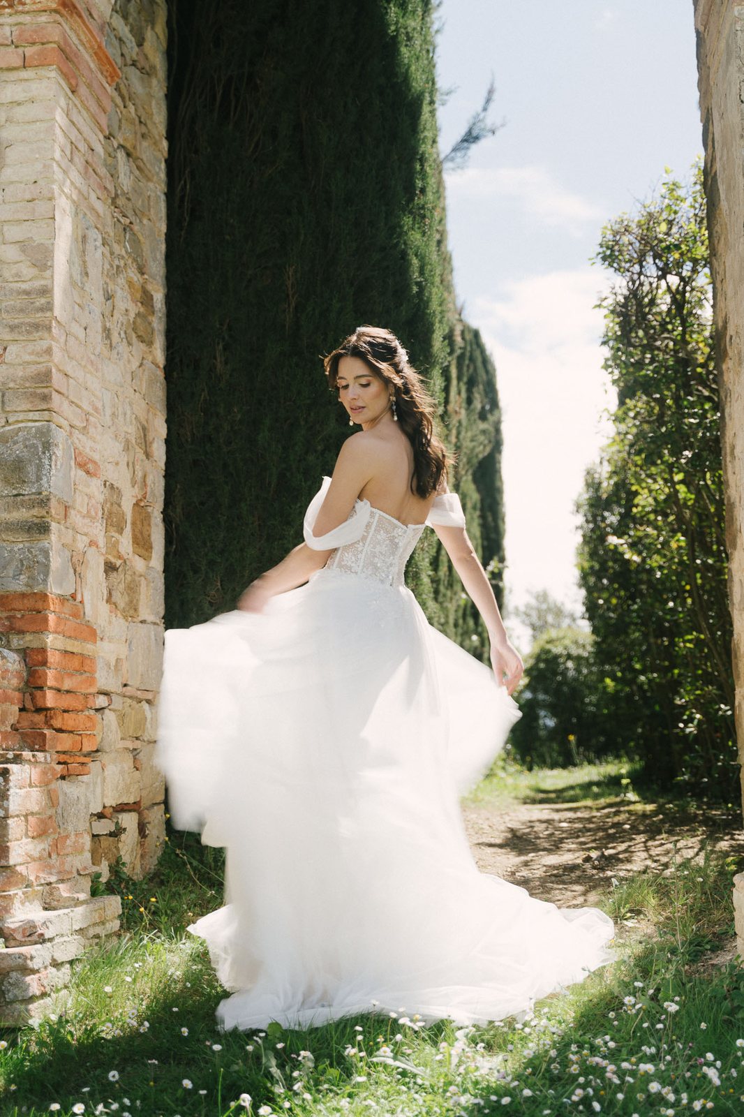 A bride between cypresses, full sun — after the preset