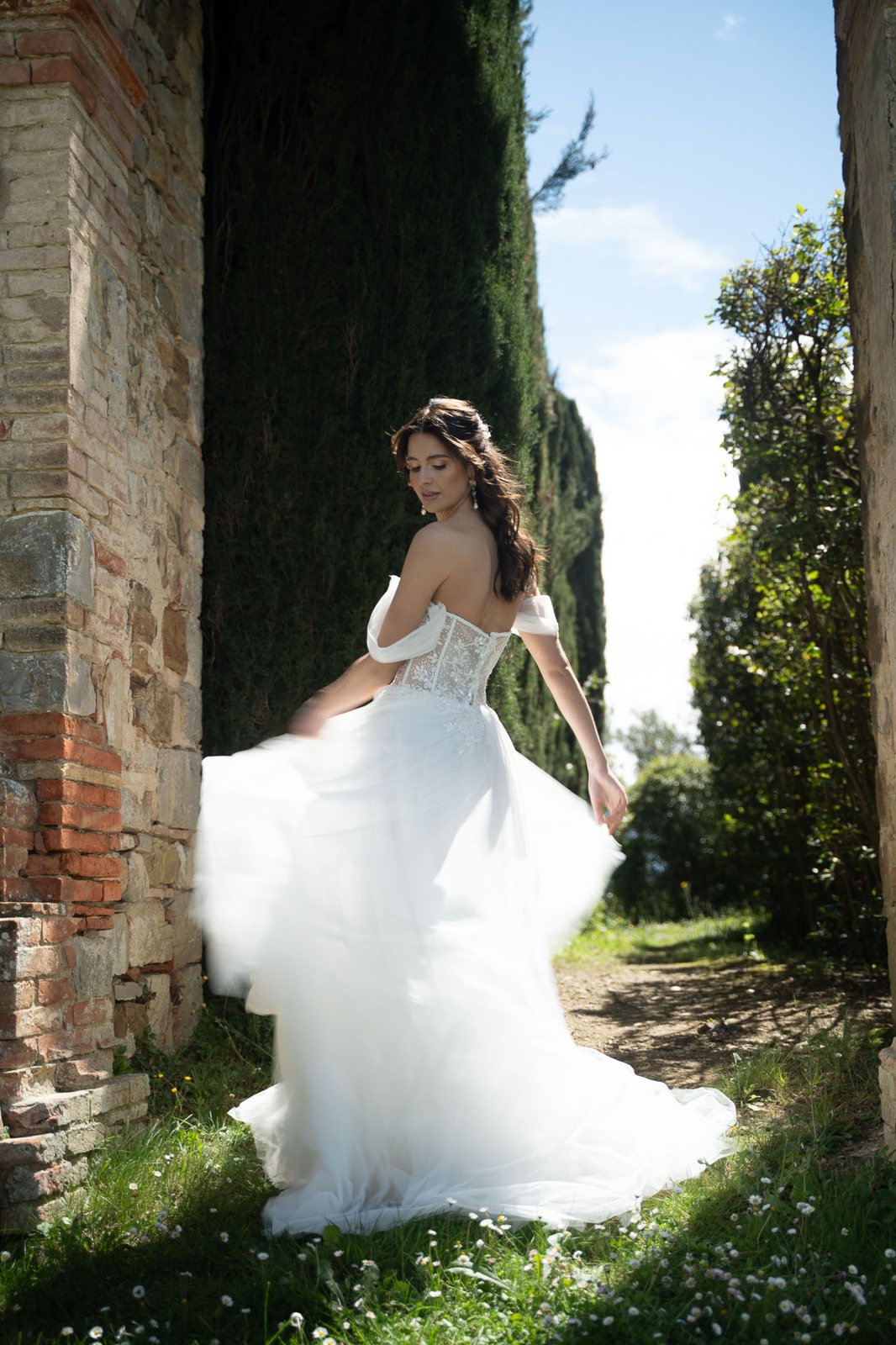 A bride between cypresses, full sun — before the preset