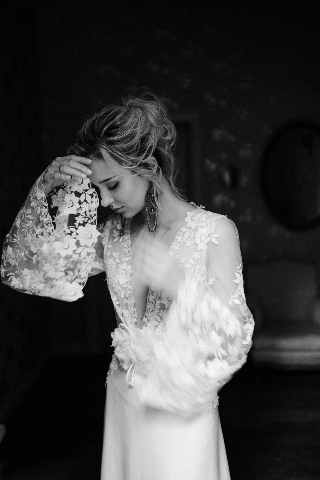 A bride in a lace gown, photographed in black and white